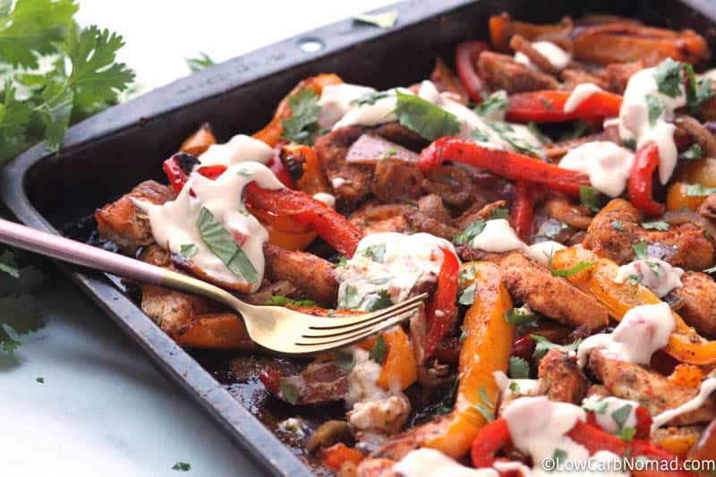 sheet pan fajitas out of the oven with white queso