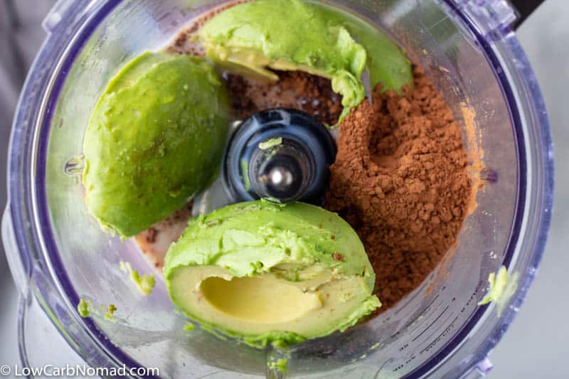 Avocado, cocoa powder, sweetener and coconut milk in a food processor to make keto avocado chocolate pudding