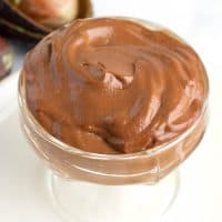 large glass dish full of chocolate avocado pudding that is low carb and keto.