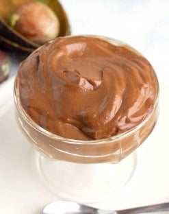 large glass dish full of chocolate avocado pudding that is low carb and keto.