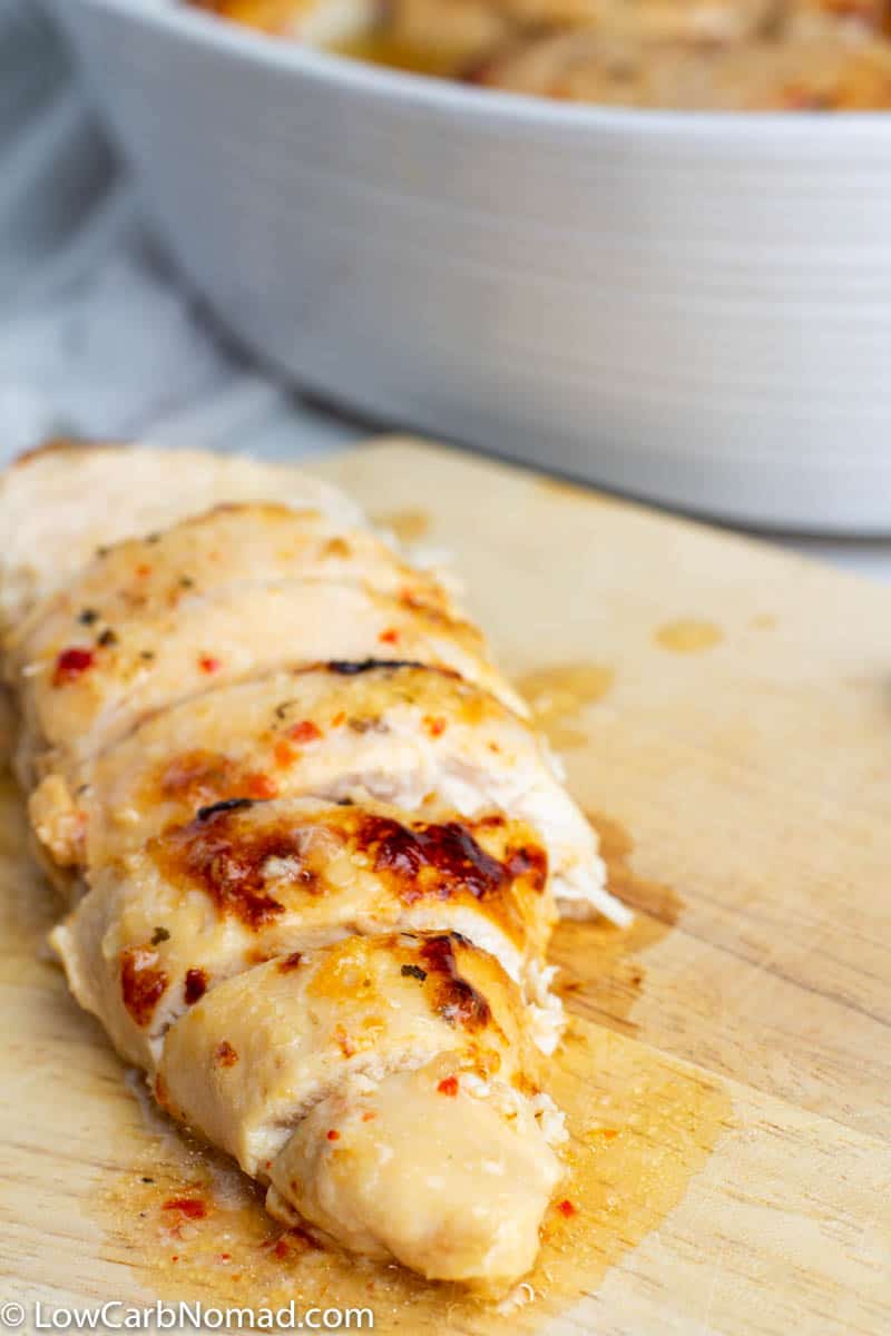 Baked Italian Chicken cooked on sliced on a cutting board