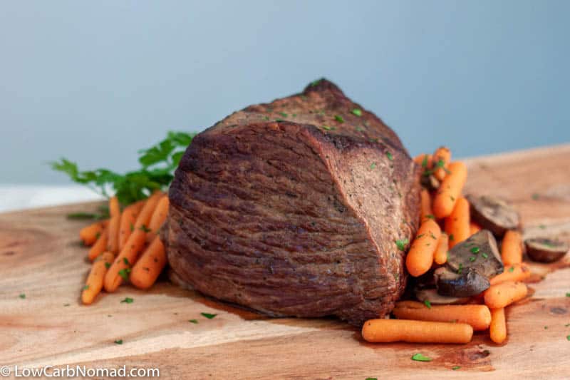 roast beef on table with vegetables