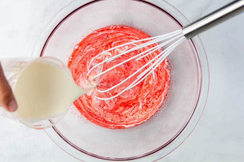 heavy cream being added to water and jello mixture