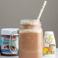 keto milkshake in a glass with a straw