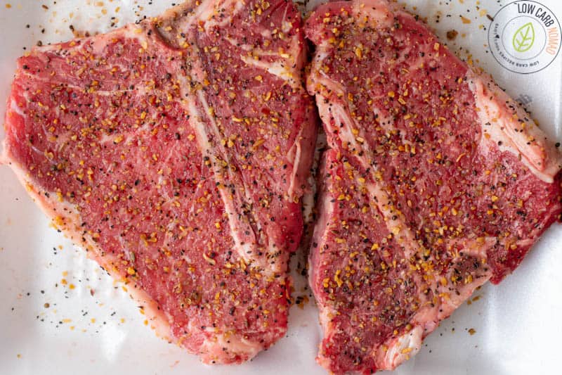 raw steaks with seasoning