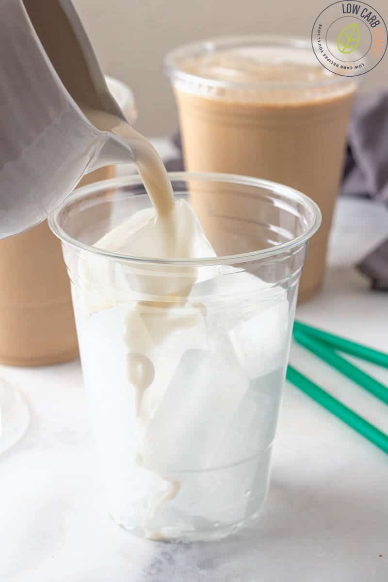 pouring iced coffee into cup