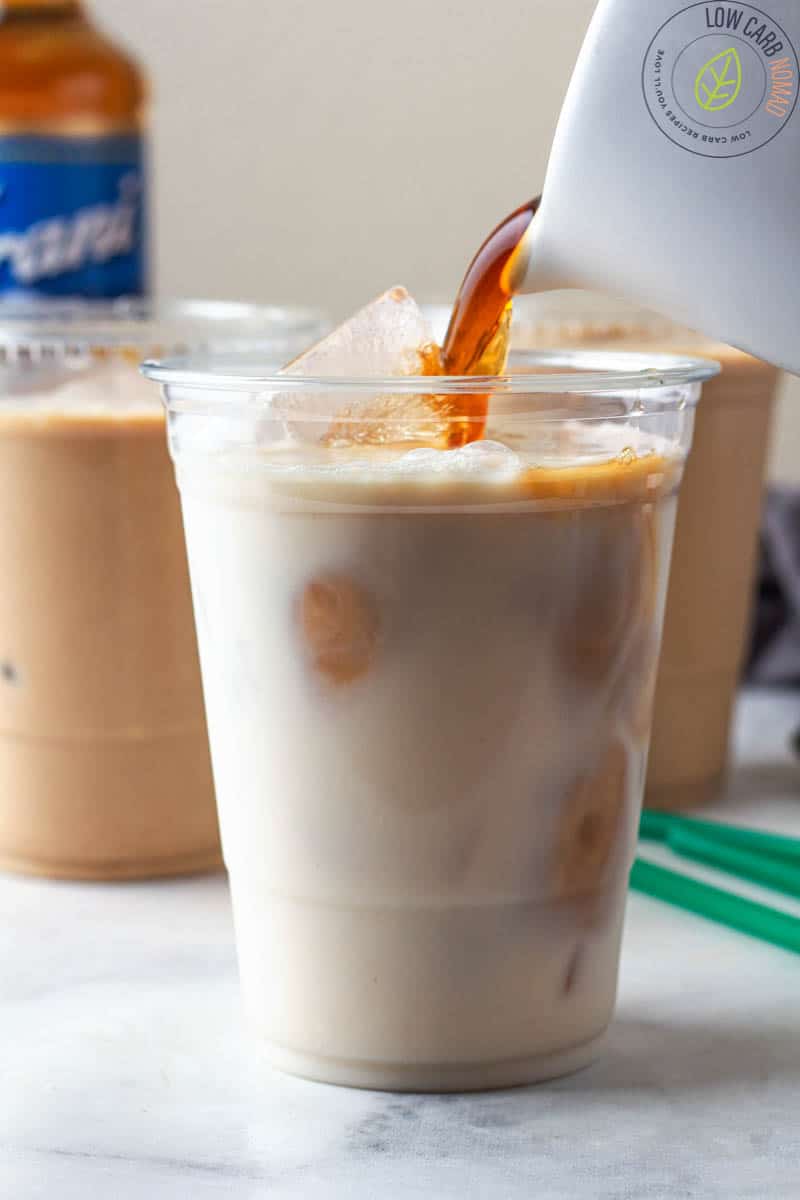 pouring iced coffee into cup