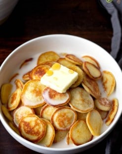 low carb pancakes in a bowl to make pancake cereal with milk, butter and sugar free maple syrup