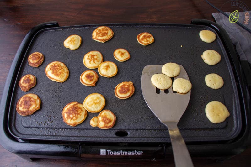 flipping pancakes on cooktop