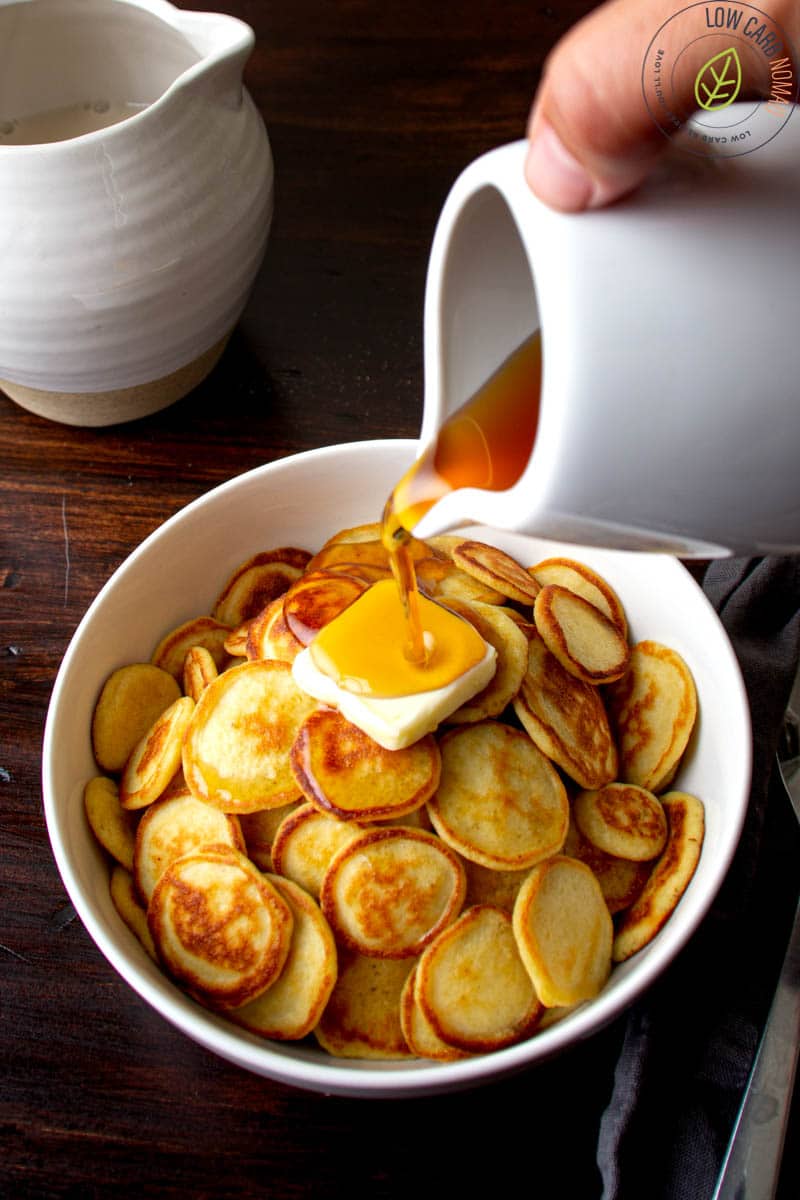 mini keto pancakes in a bowl with butter and sugar free syrup