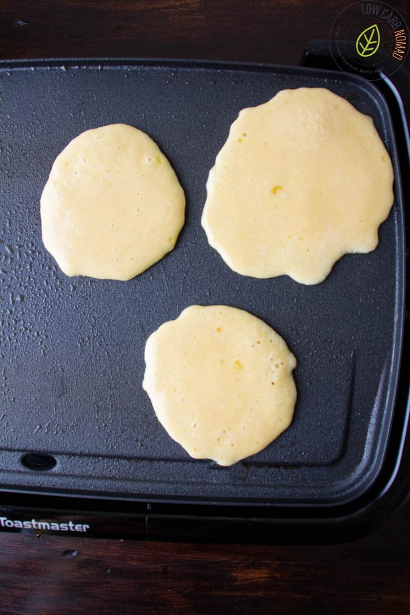 keto pancakes on a griddle cooking