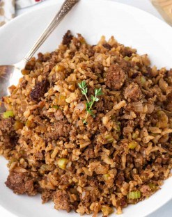 Keto Cauliflower stuffing with sausage in a bowl with a metal spoon