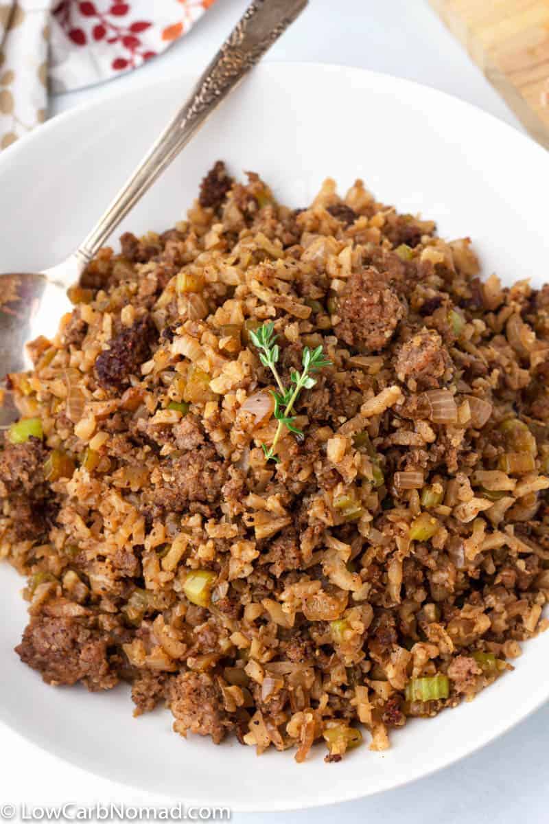 Keto Cauliflower stuffing with sausage in a bowl with a metal spoon