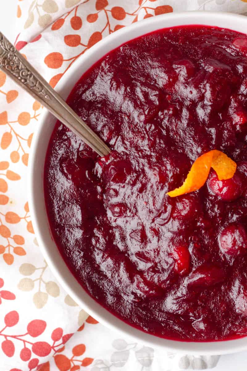 A bowl of sugar free cranberry sauce with a spoon in the bowl