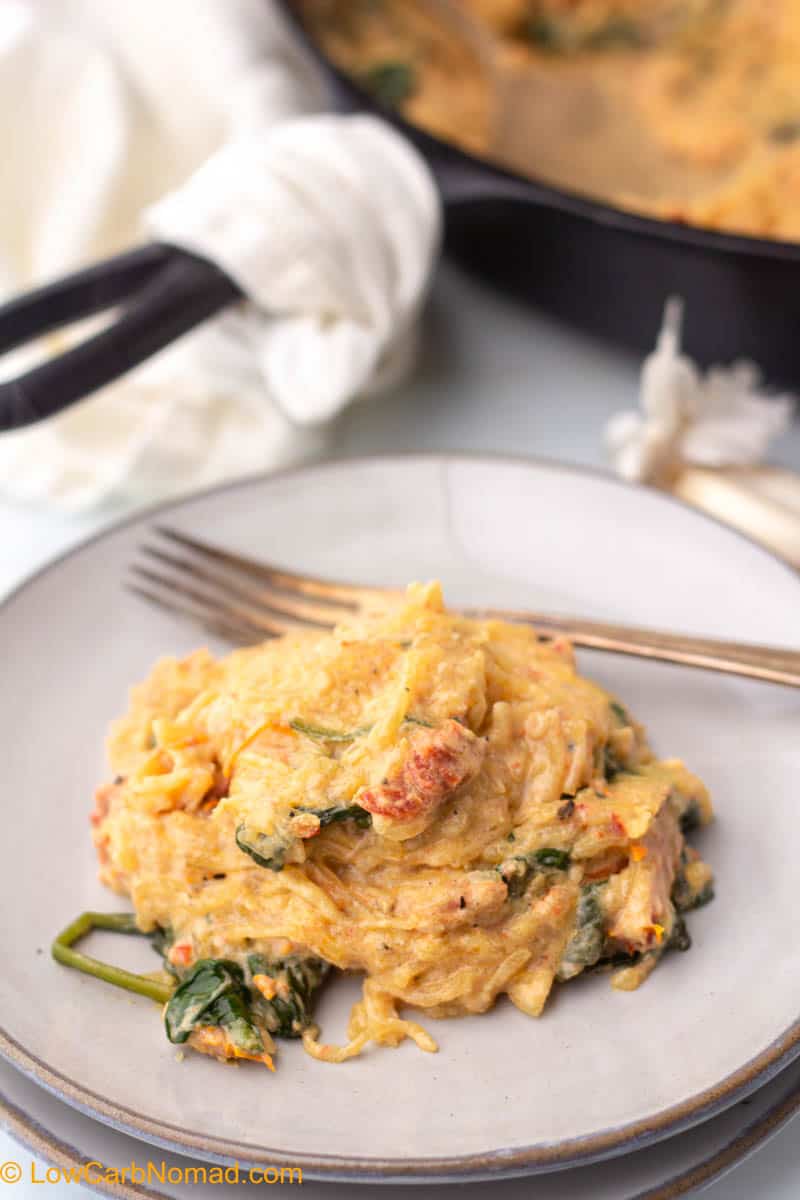 Roasted spaghetti squash with tomato and spinach on a plate