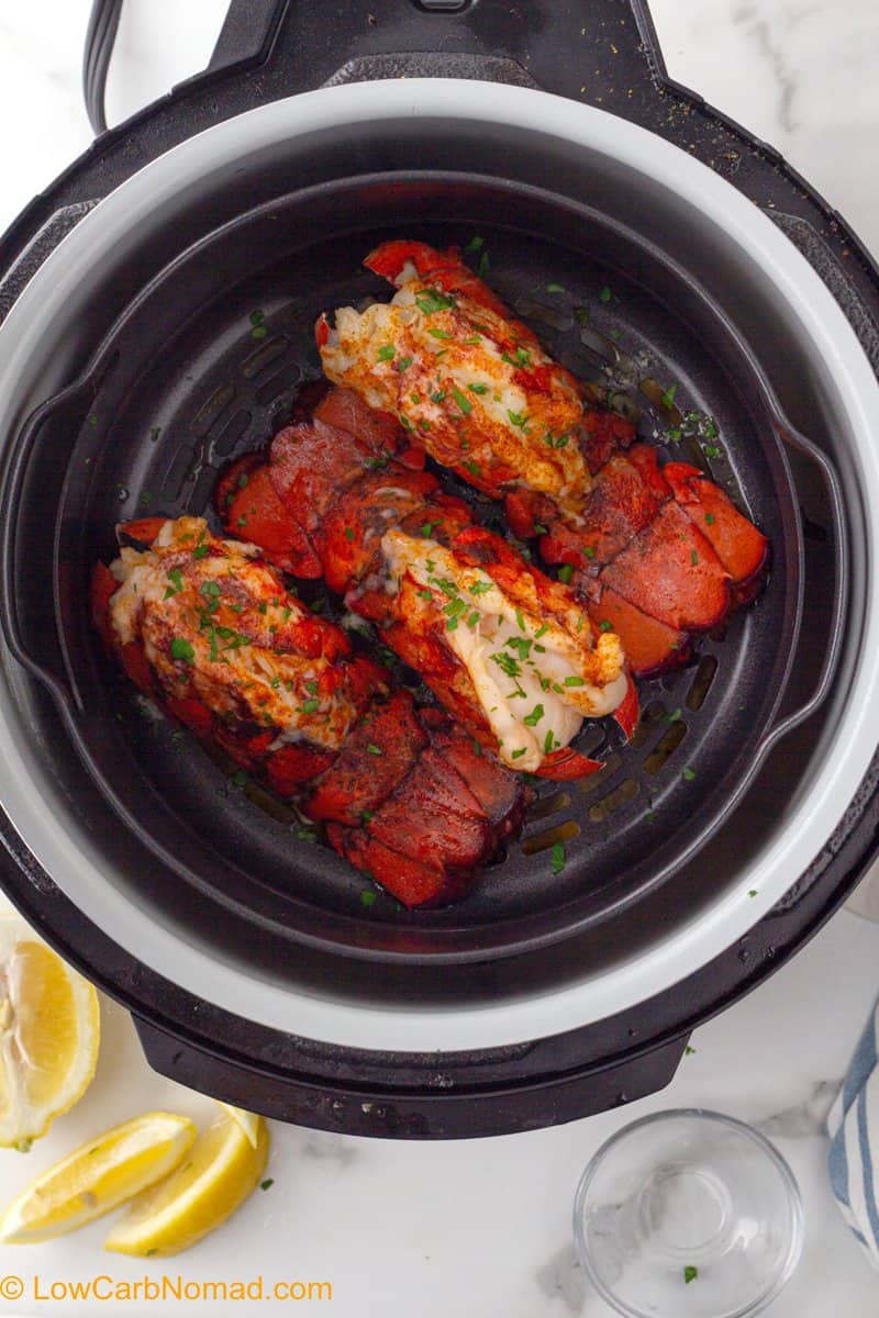 Cooked lobster tails in the air fryer basket