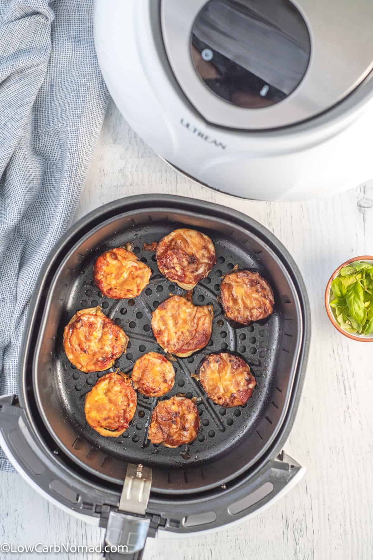 cooked Keto low carb eggplant pizza bites in an air fryer basket