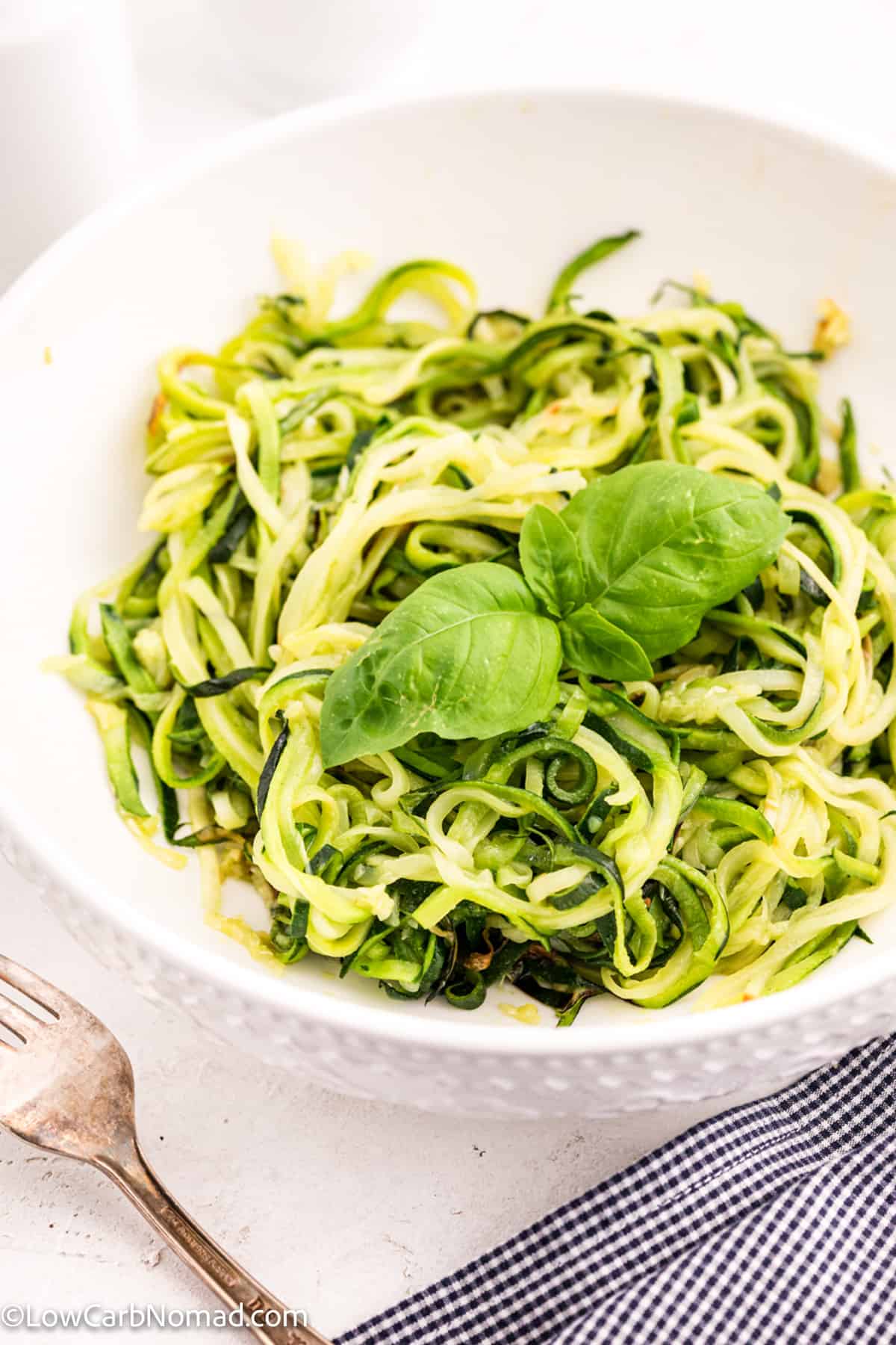 close up photo of a bowl of zucchini noodles