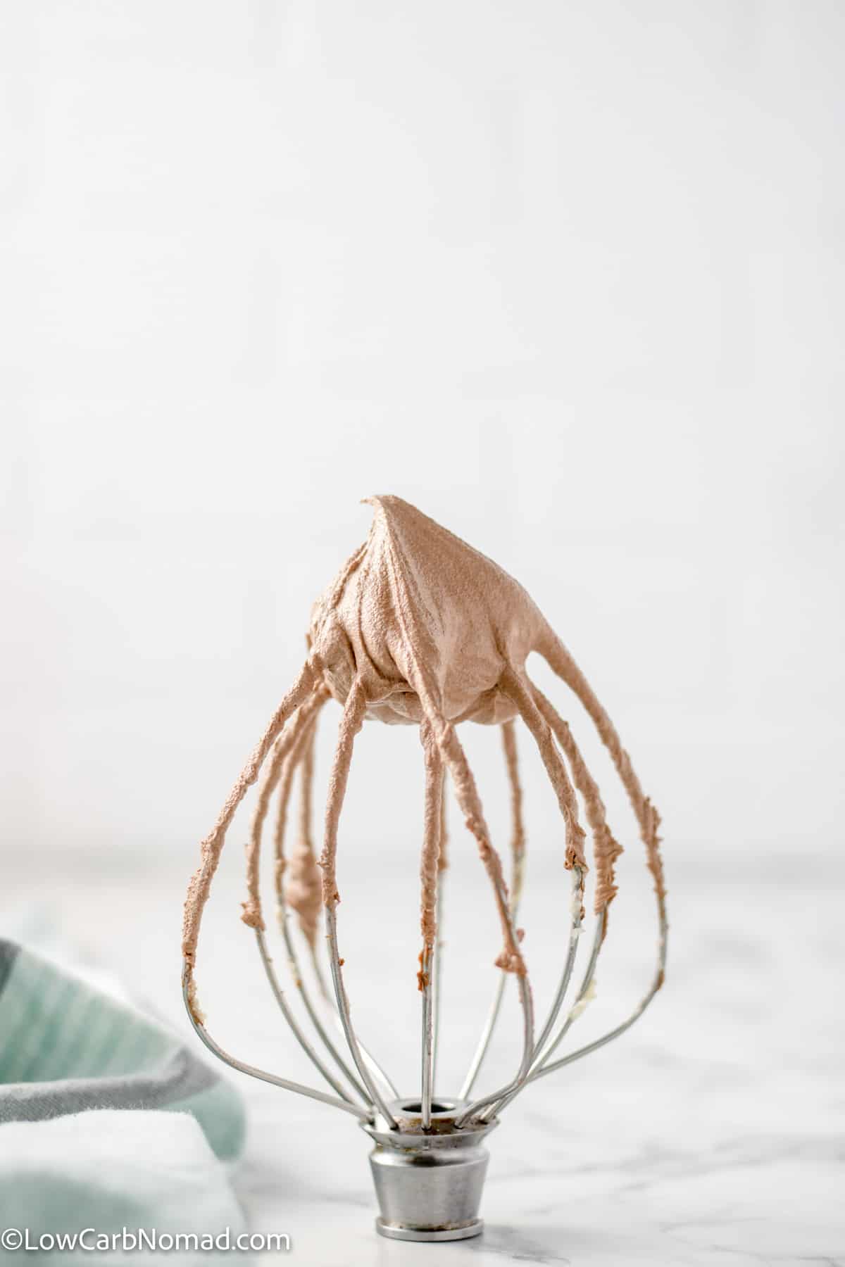 Sugar free chocolate buttercream Frosting on the whisk of a stand mixer