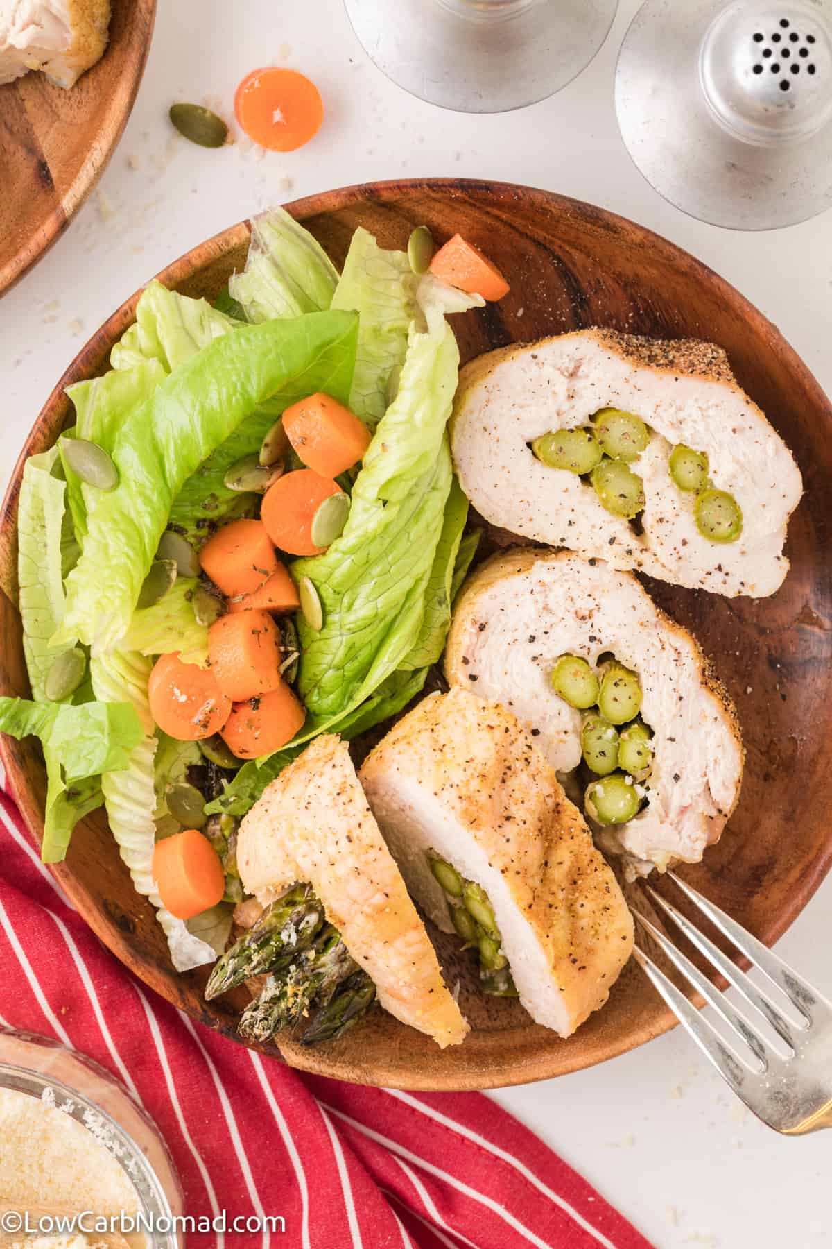 Keto asparagus stuffed chicken on a plate served with a side salad