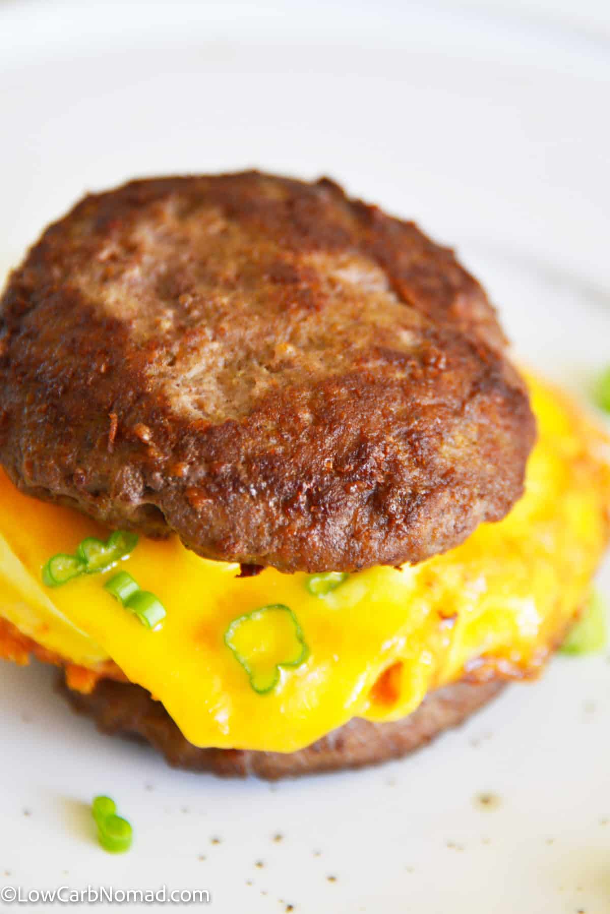 close up photo of Keto Sausage Egg and Cheese Breakfast Sandwich on a plate 