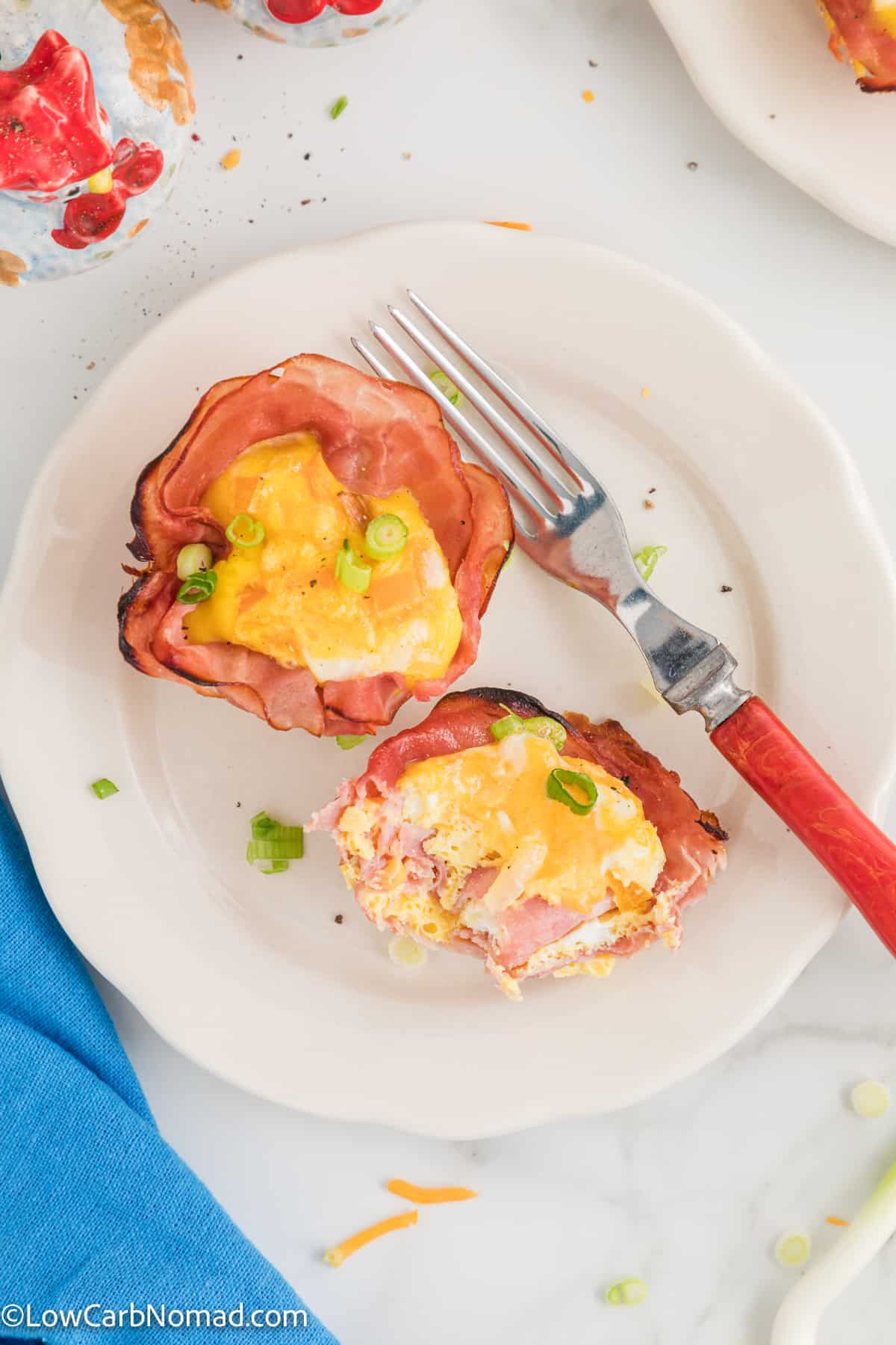 overhead photo of 2 egg muffins with ham on a plate