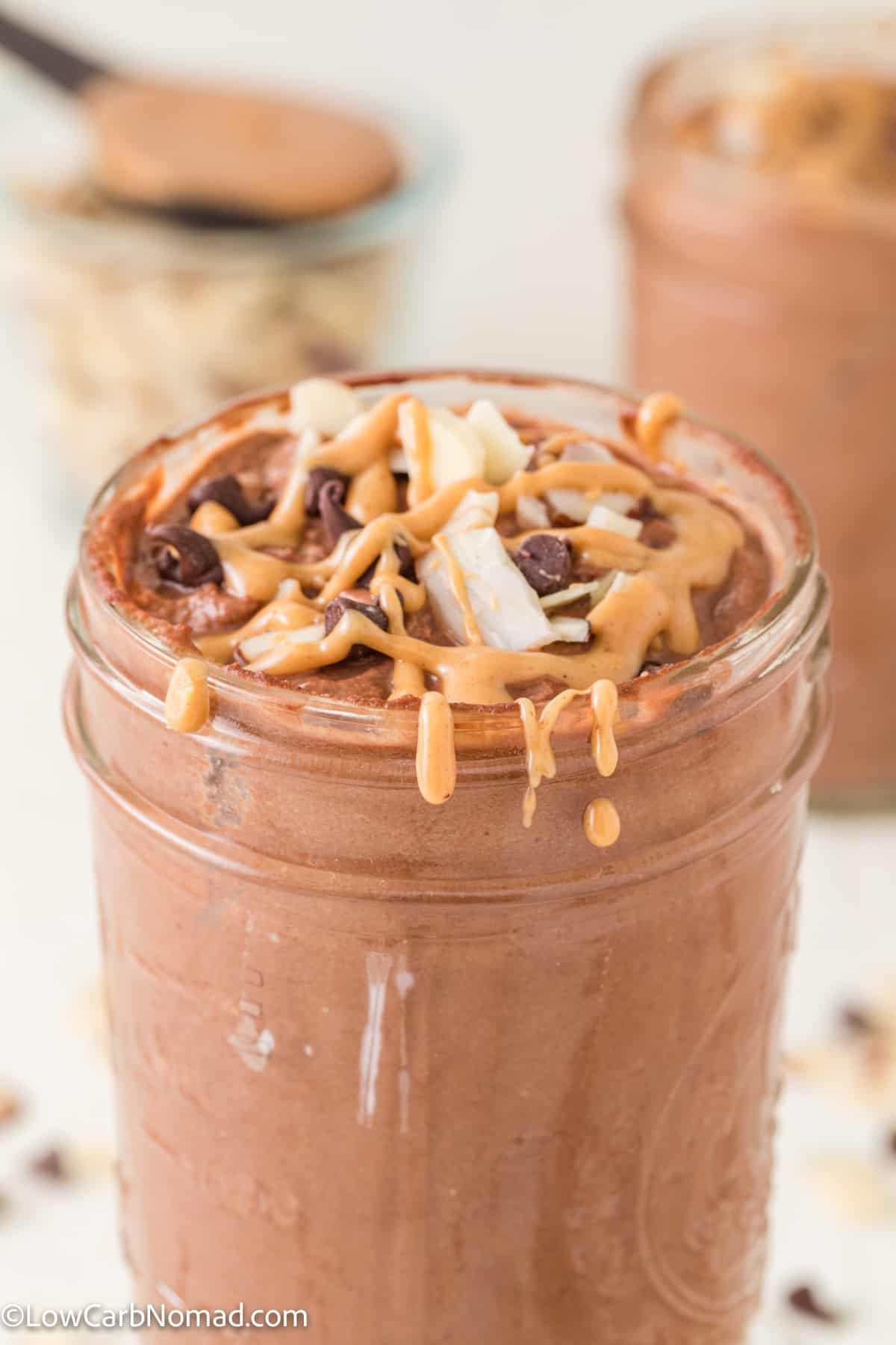 Keto Frosty Recipe topped with sugar free chocolate chips and melted peanut butter
