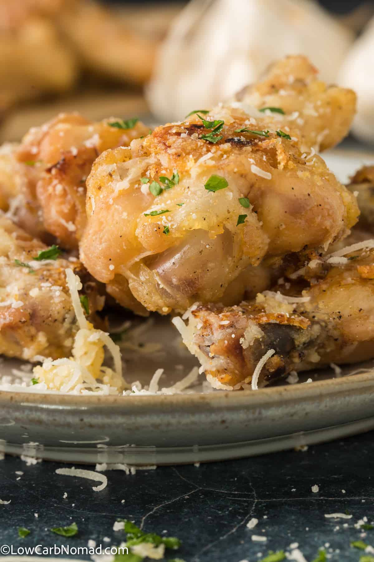 close up photo of Garlic Parmesan Chicken wings on a plate