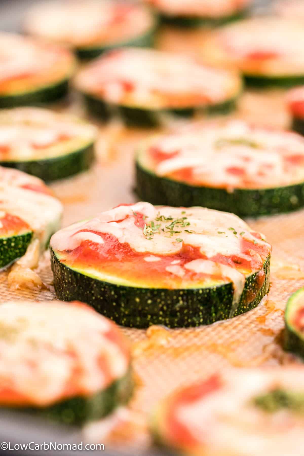 close up photo of Zucchini Pizza Bites on a baking sheet